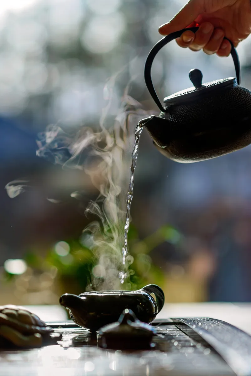 Tea being poured as part of a hospitality service
